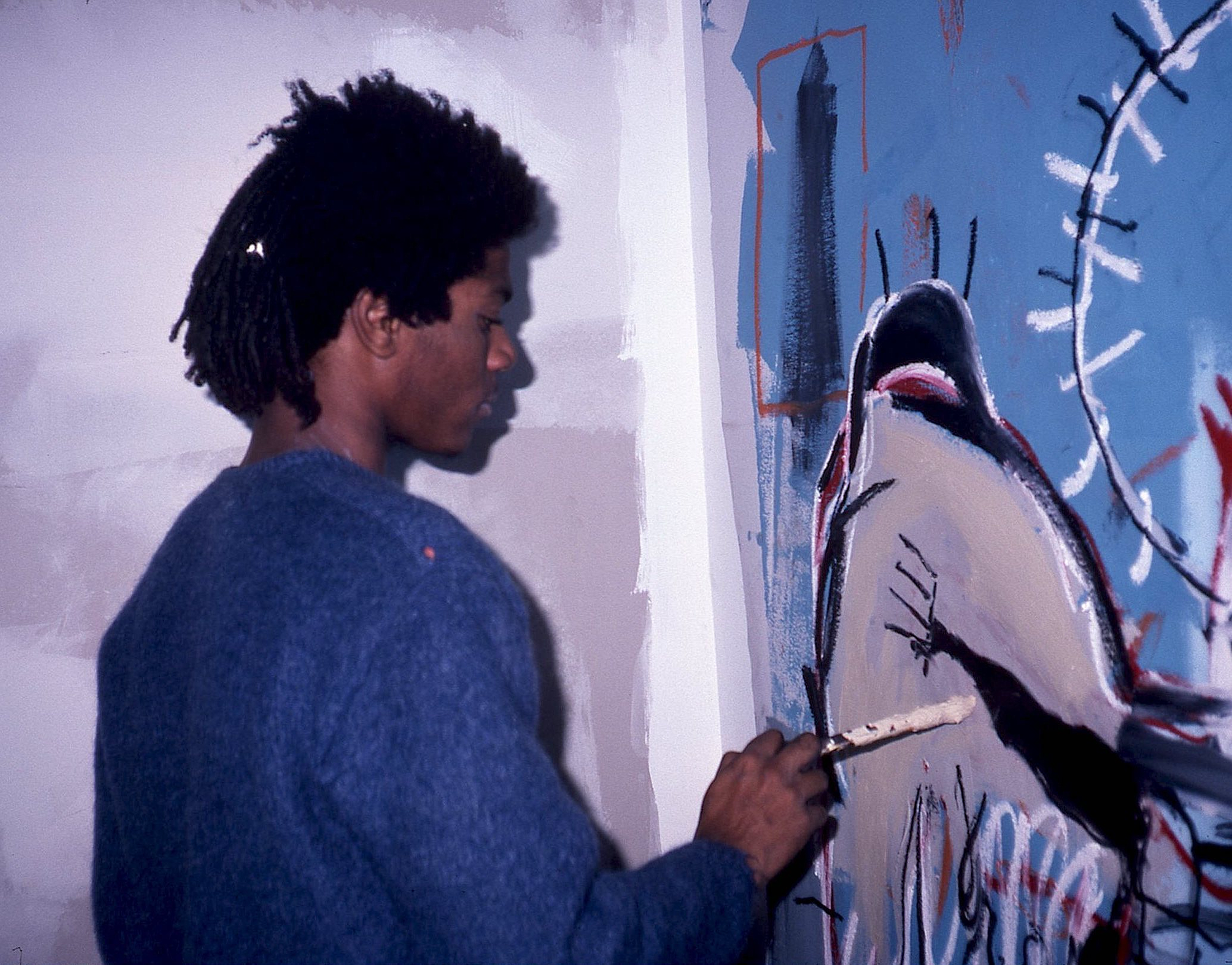 Jean Michel Basquiat in his first studio space, 1981. by Seth Tillett